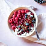 top down shot of yogurt in bowl with granola and berries