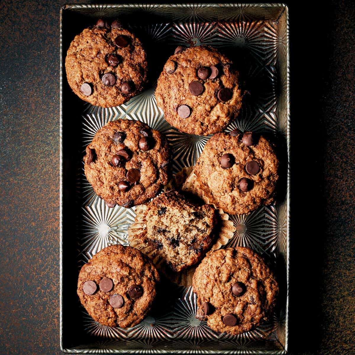 Overhead view of Vegan Banana Chocolate Chip Muffins in a metal tray.