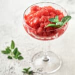 Side view of strawberry lemon gin granita in coupe glass