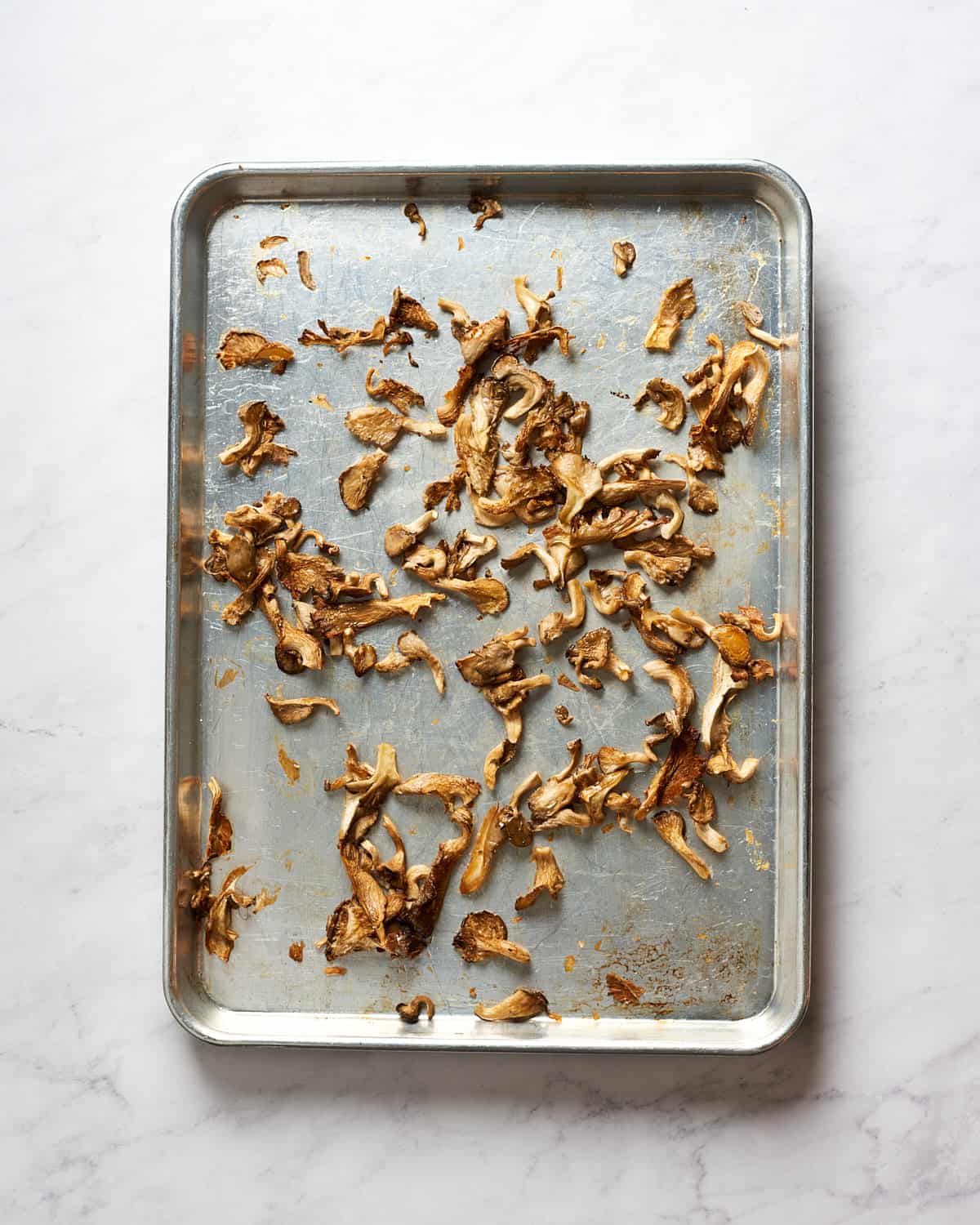 Overhead view of roasted oyster mushrooms on baking sheet