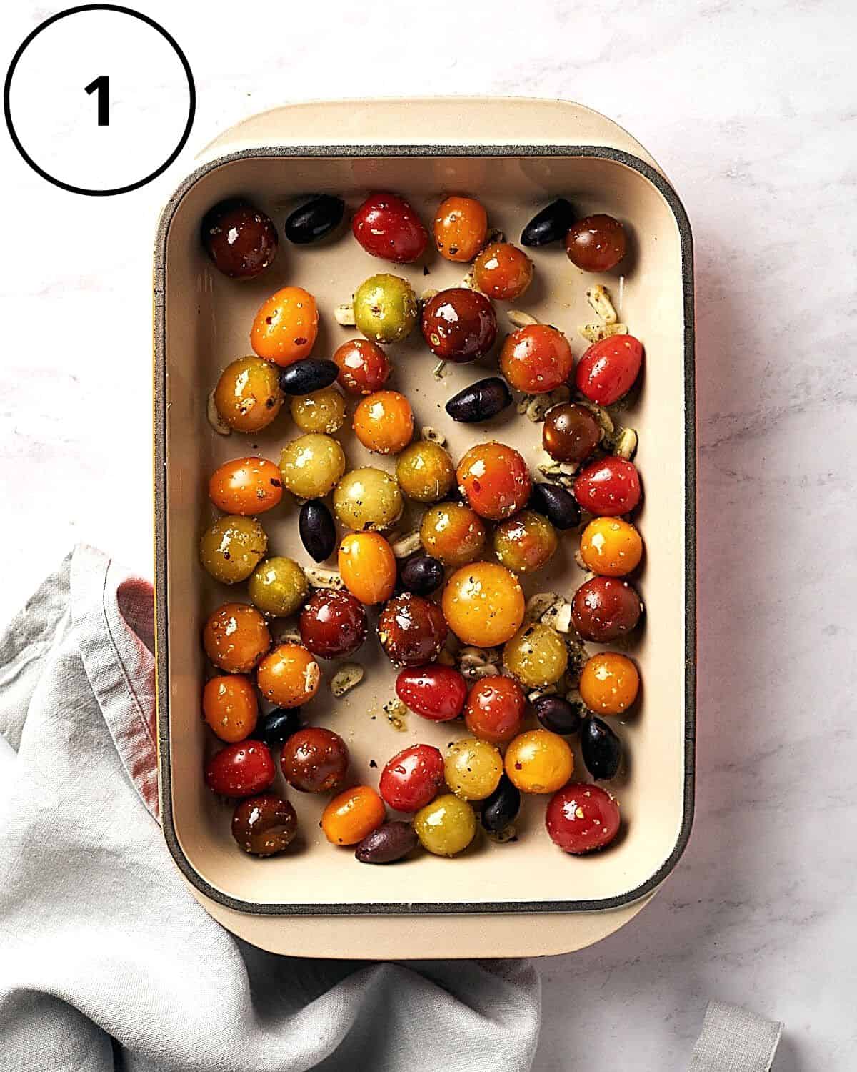 Overhead of raw cherry tomatoes in baking pan on marble background