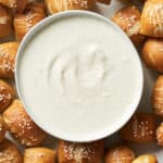 Platter of vegan pretzel bites with small bowl of vegan horseradish aioli.