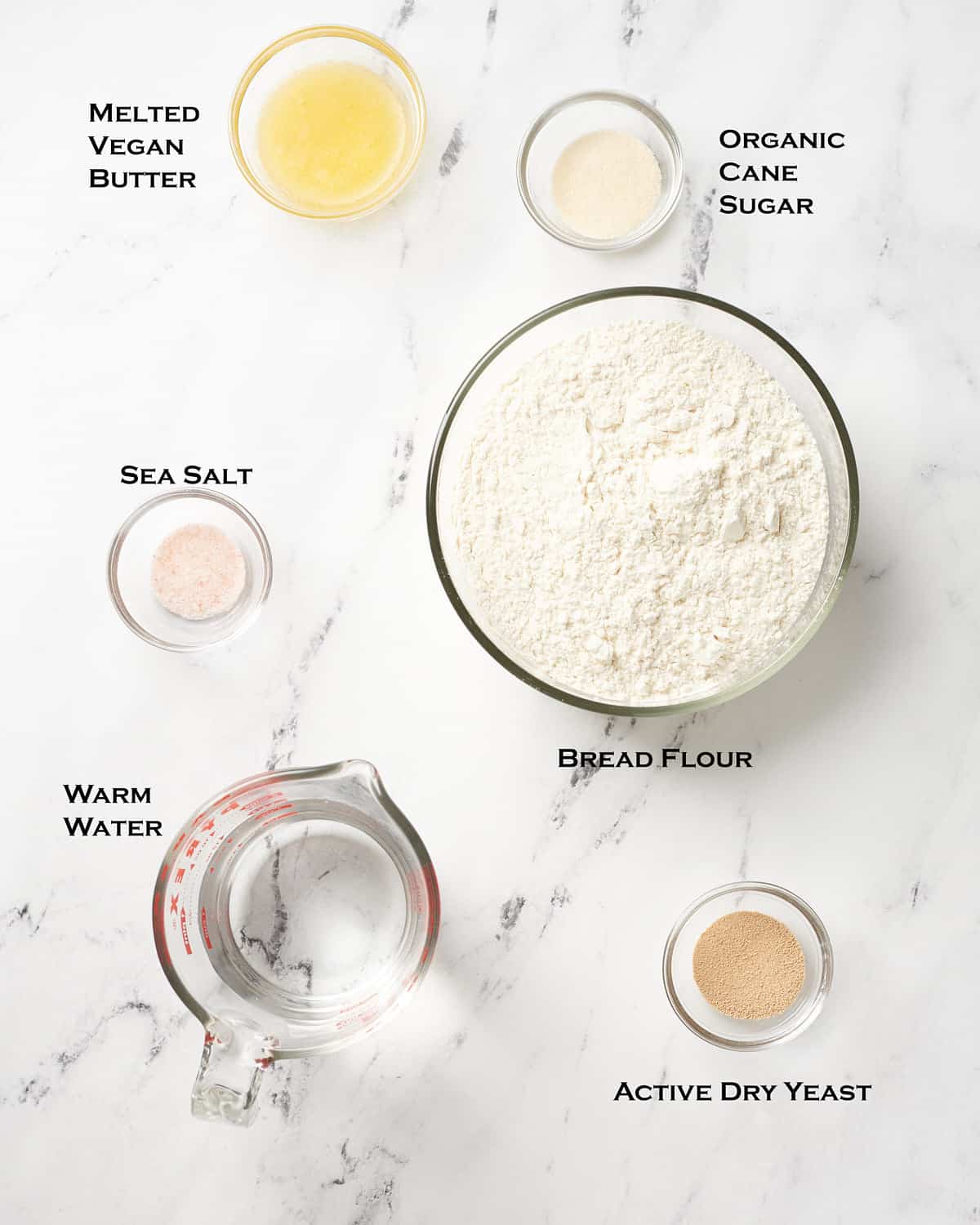 Ingredients for vegan pretzel bites on marble background
