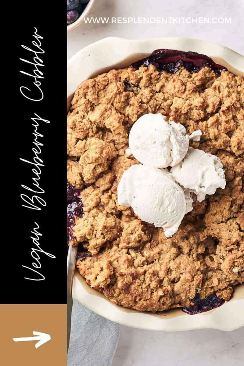 baked vegan blueberry cobbler with 3 scoops of ice cream on top