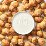 Platter of vegan pretzel bites with small bowl of vegan horseradish aioli.