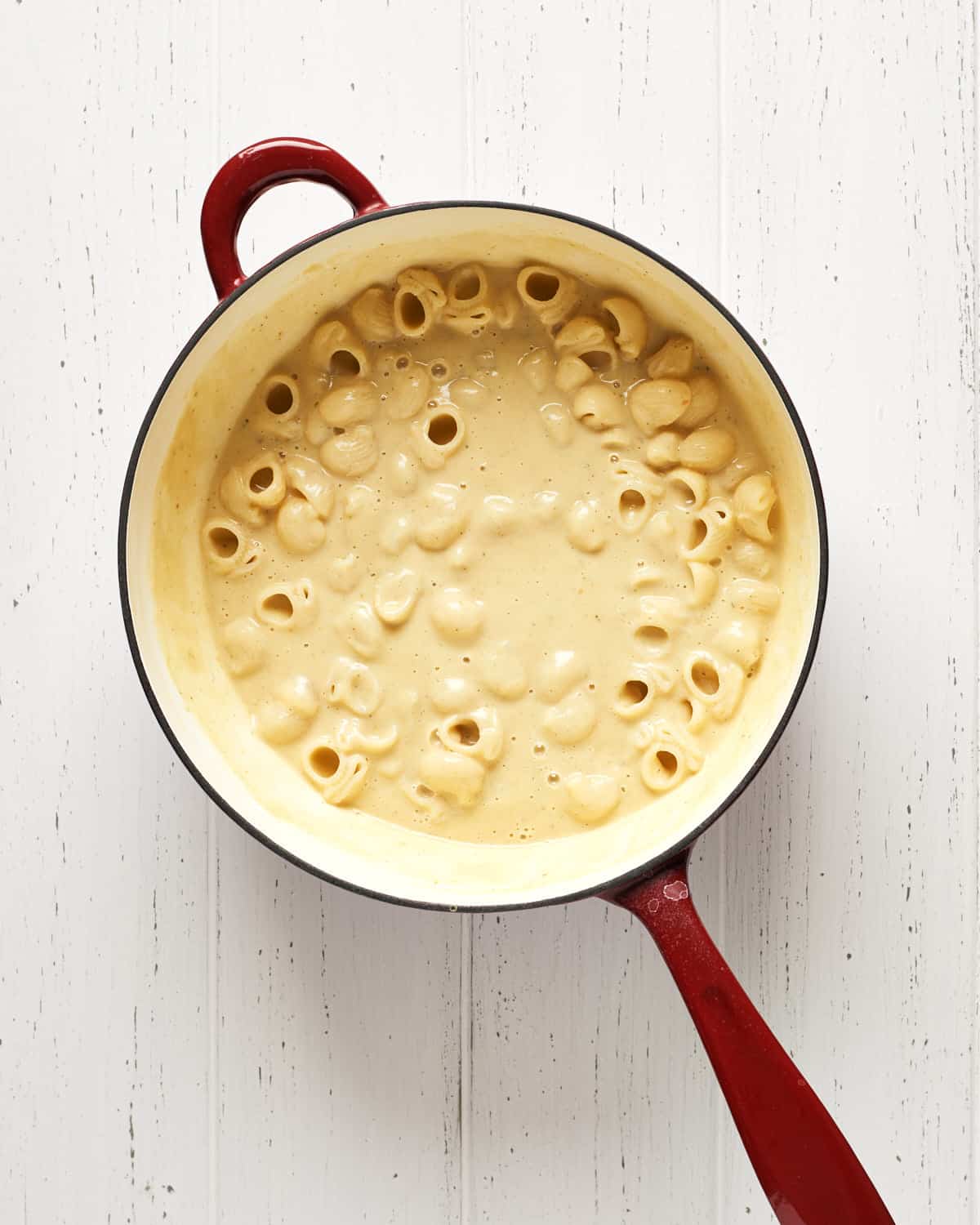 Overhead view of pasta with bean sauce in saucepan to make pasta with peas.