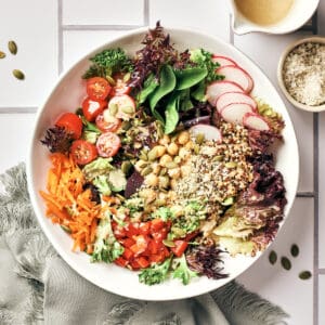 white bowl filled with vegan chickpea quinoa salad