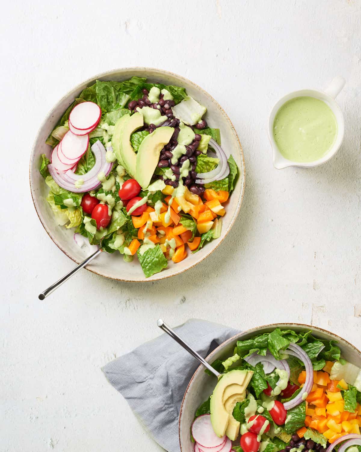 Two bowls of Southwest Salad with dressing