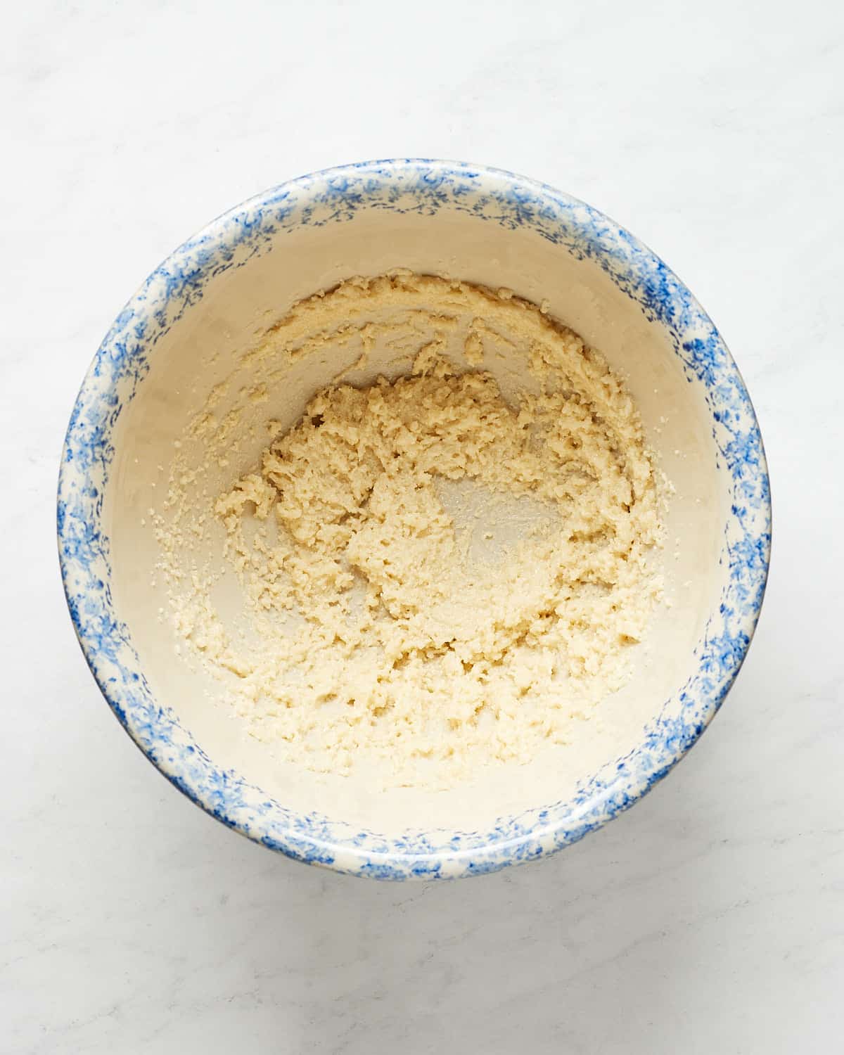 MIxing vegan butter and sugar in large bowl.