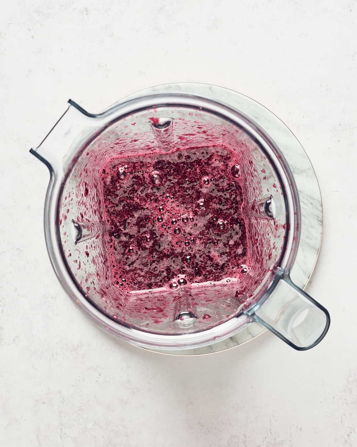 Top down view of cherry compote in blender.
