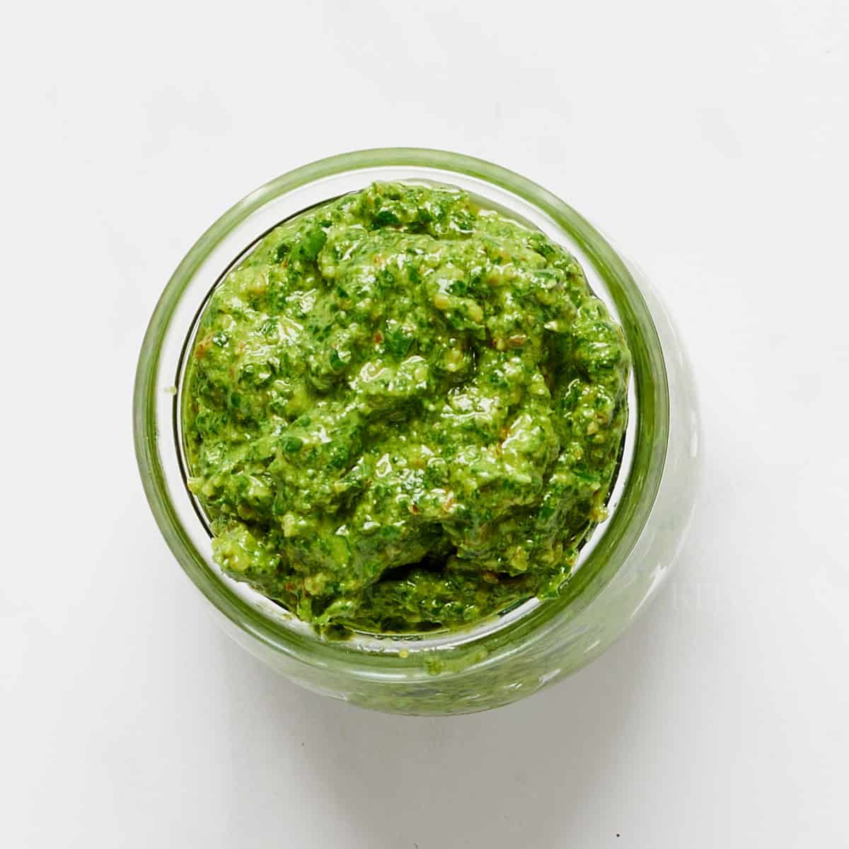 Overhead of Vegan Walnut Pesto in glass jar.