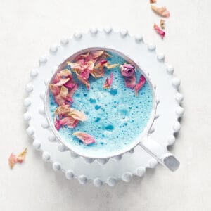 Overhead view of Vegan Butterfly Pea Flower Latte on greu sirface
