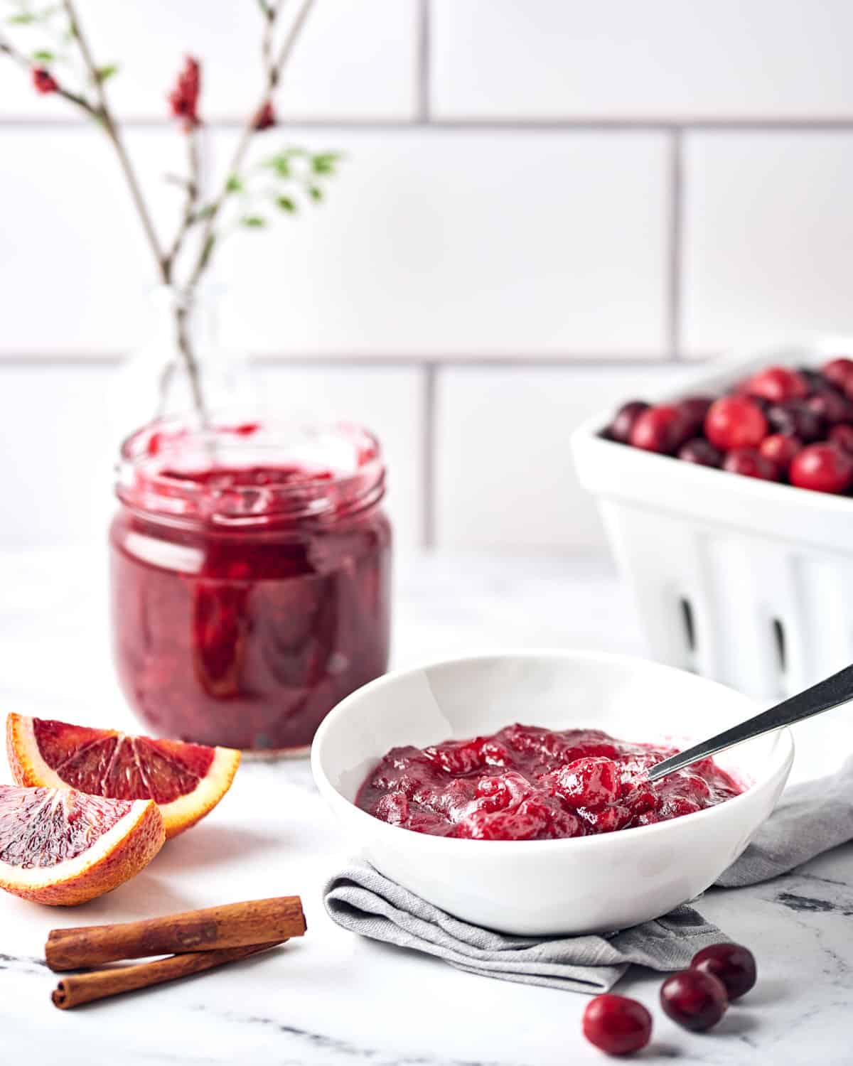Cranberry Sauce with Orange in a white bowl on a marble surface.
