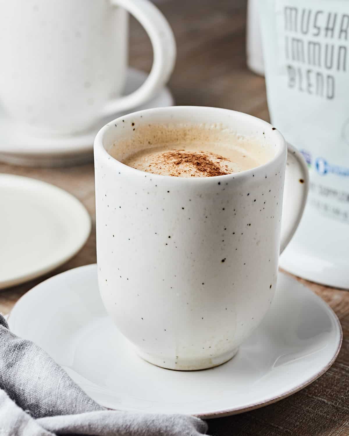 Side view of Vegan Mushroom Latte in Mug with sprinkle of cinnamon.