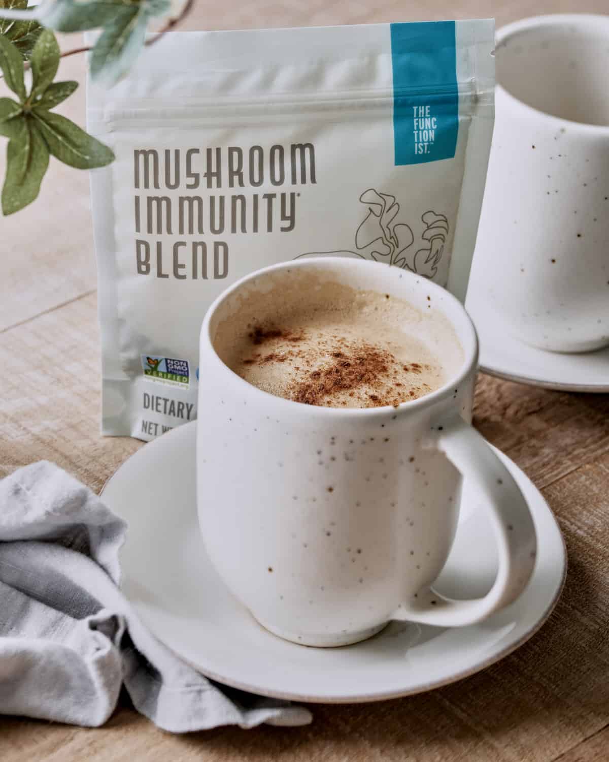 Side view of vegan mushroom latte in cup with mushroom immunity blend.