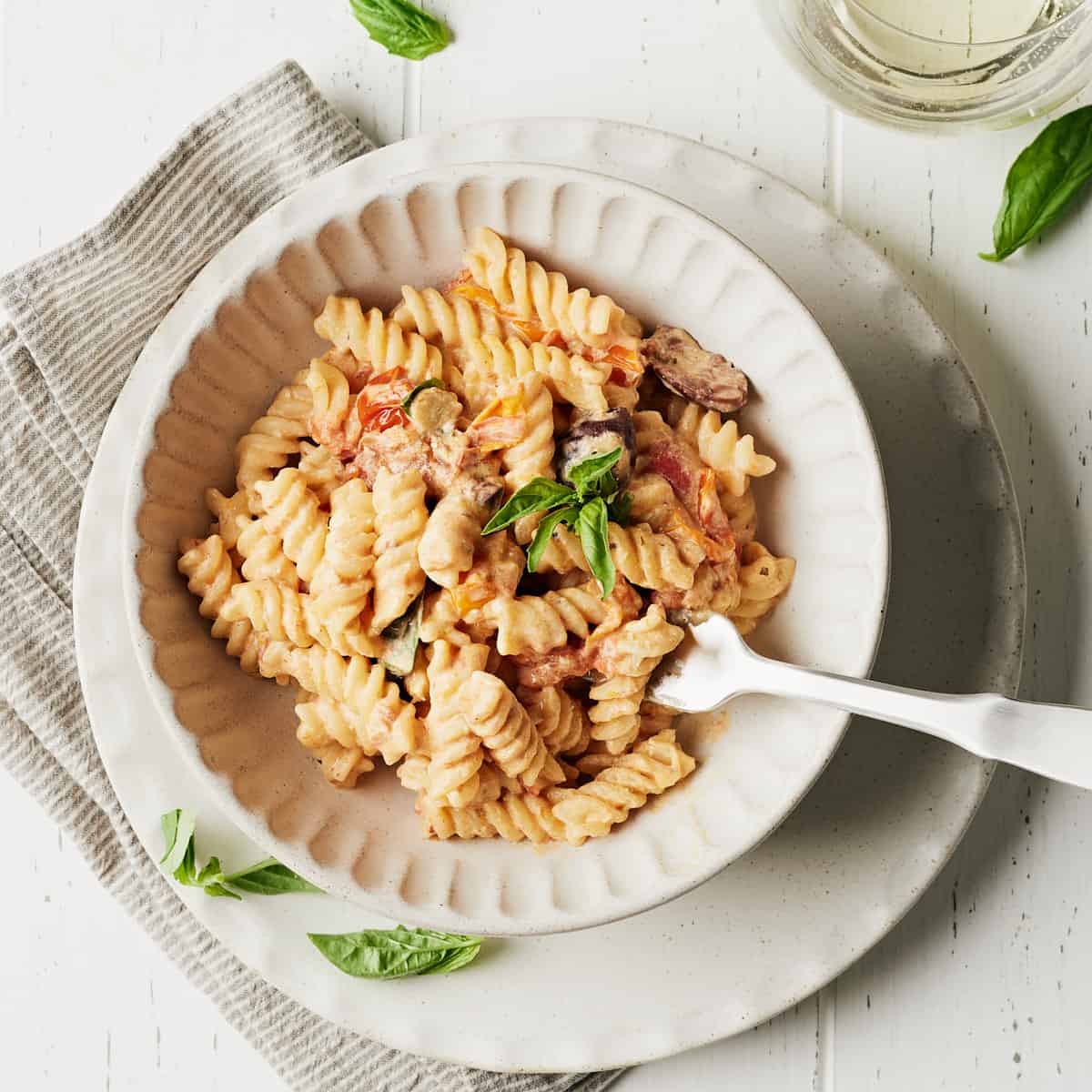 Overhead view of Vegan Creamy Roasted Tomato Garlic Pastain bowl with fork.