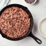 Overhead view of Vegan Peanut Butter Chocolate Skillet Cookie in cast iron skillet.