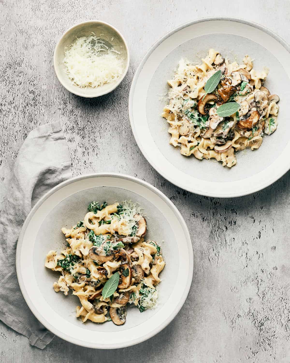 Overhead view of two bowls of vegan creamy mushroom pasta.