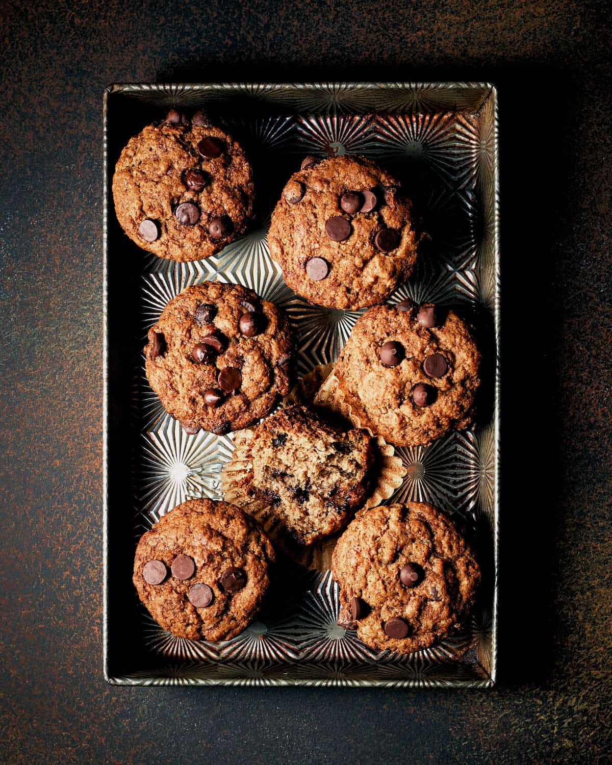 Overhead view of Vegan Banana Chocolate Chip Muffins in muffin tin.