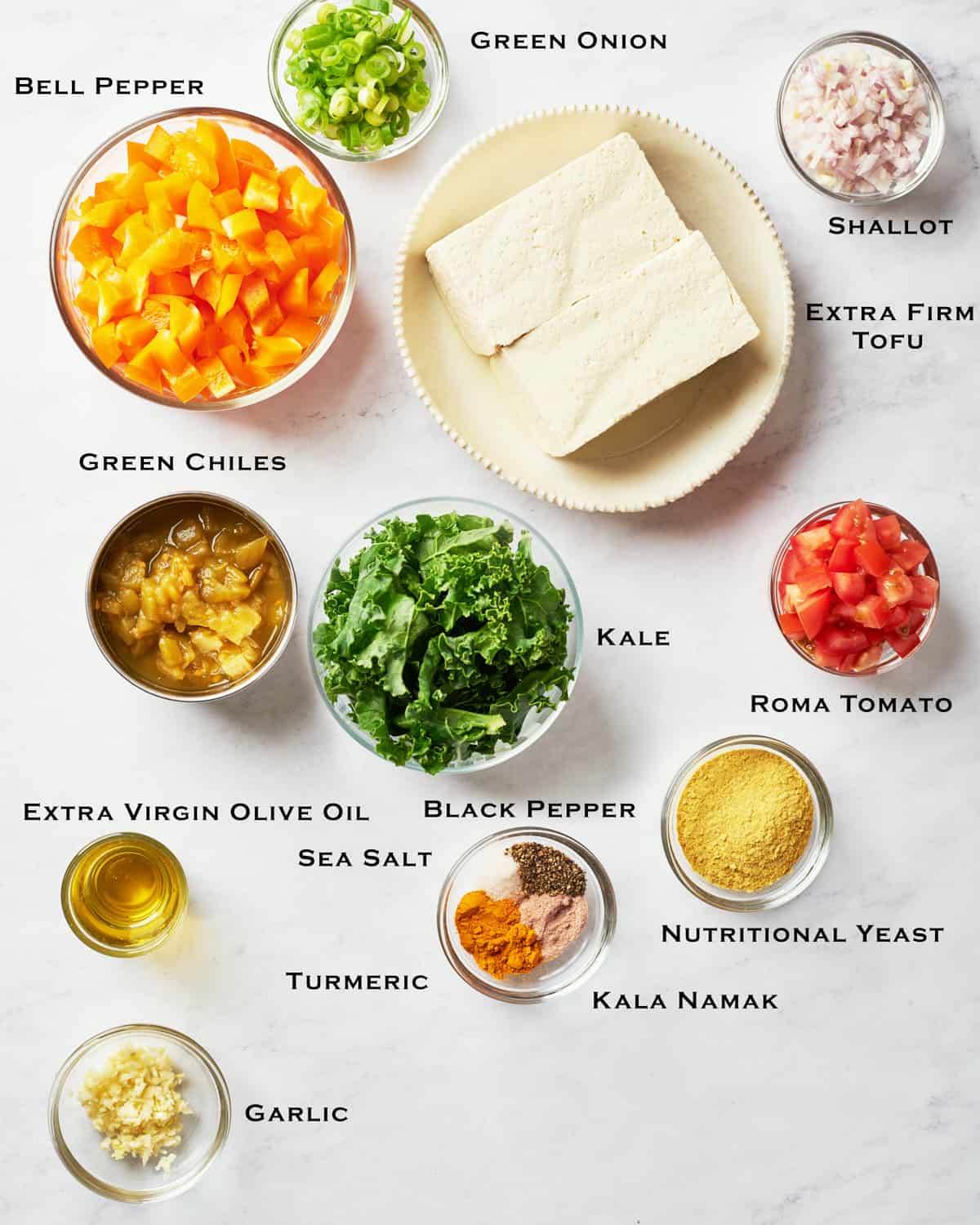 Overhead view of easy vegan southwestern tofu scramble ingredients on a marble surface.