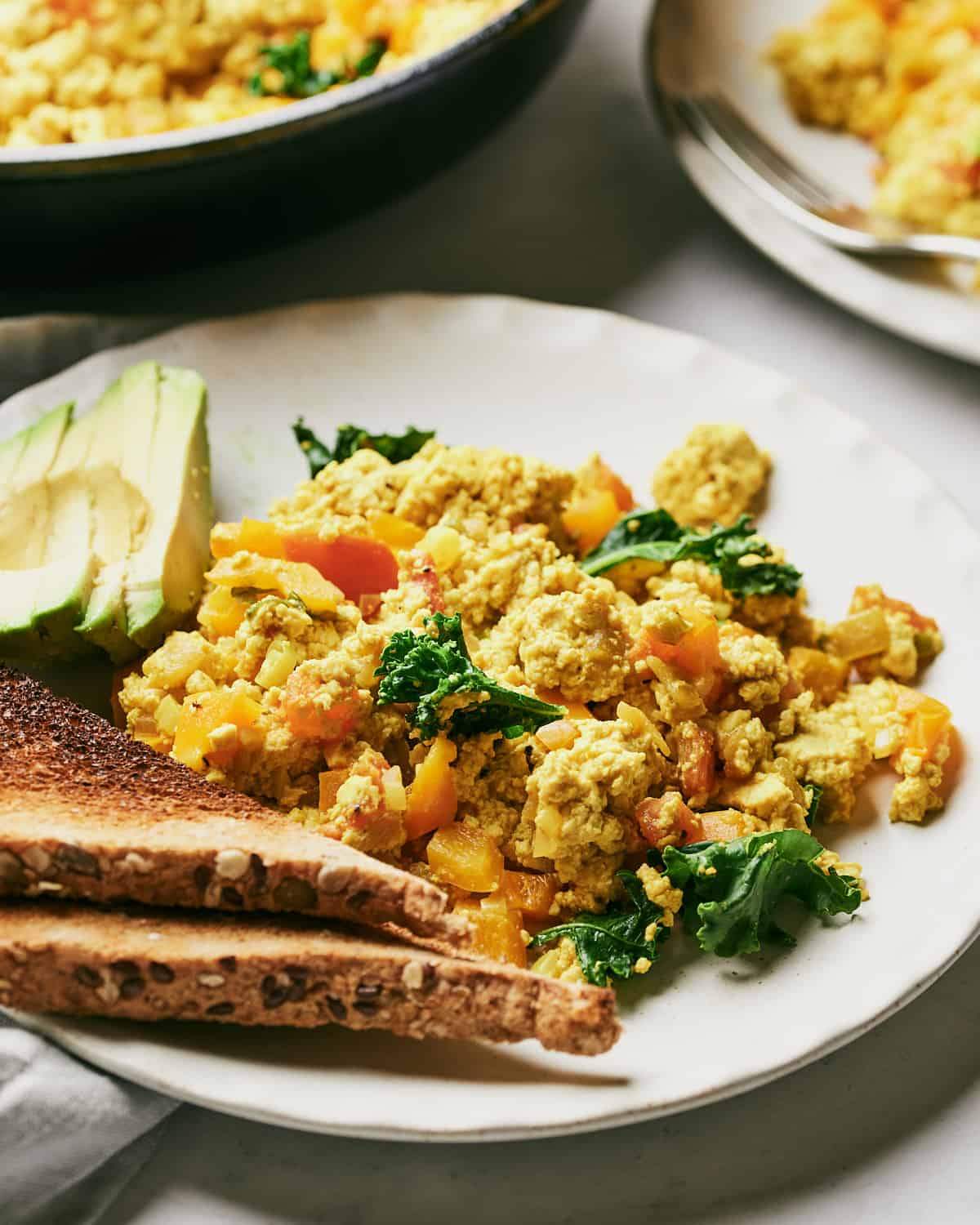 Overhead view of Homemade Vegan Southwestern Tofu with Avocado and Toast on a Plate.