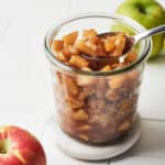 Side angle view of simple apple compote in a glass jar.