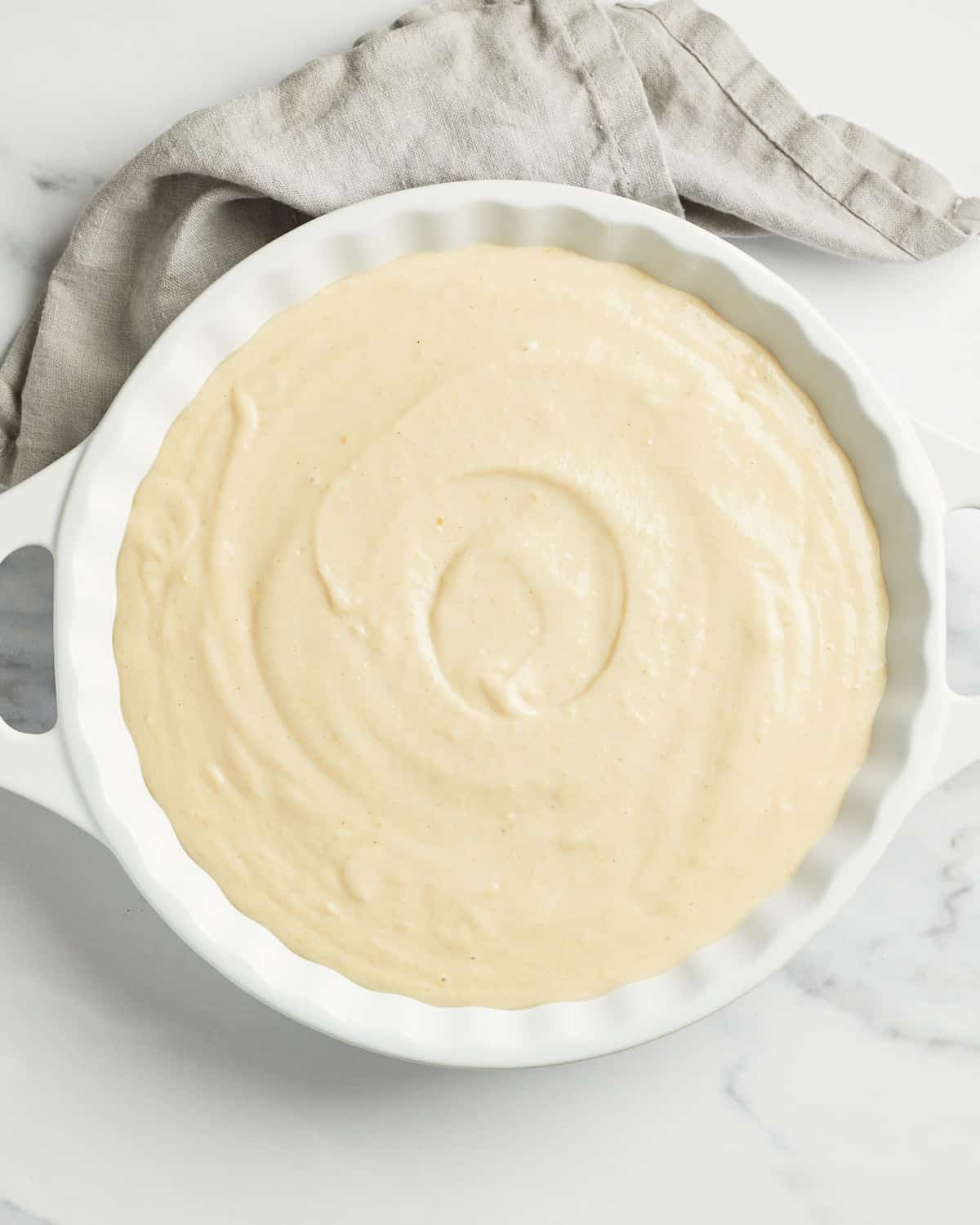 Overhead view of vegan clafoutis batter after being poured into baking dish.