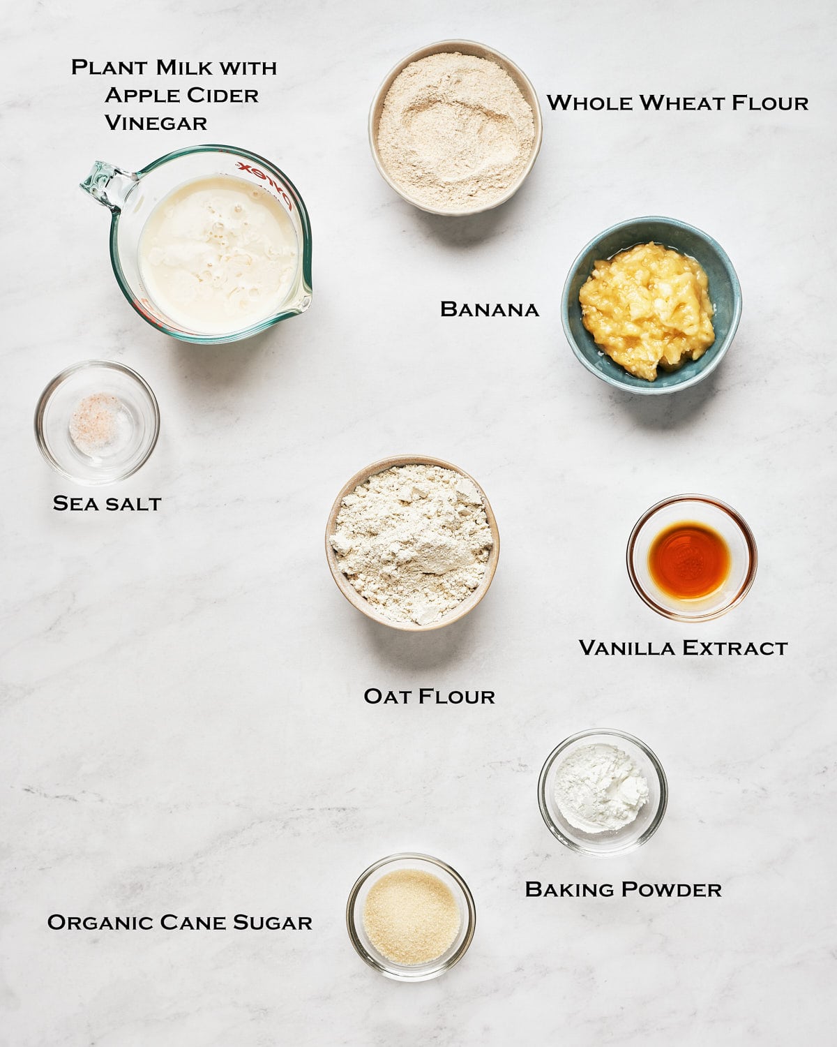 Overhead view of Vegan Banana Oatmeal Pancakes Ingredients on a marble surface.