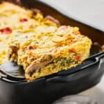 Slice of Vegan JUST Egg Frittata on a spatula near the casserole dish.