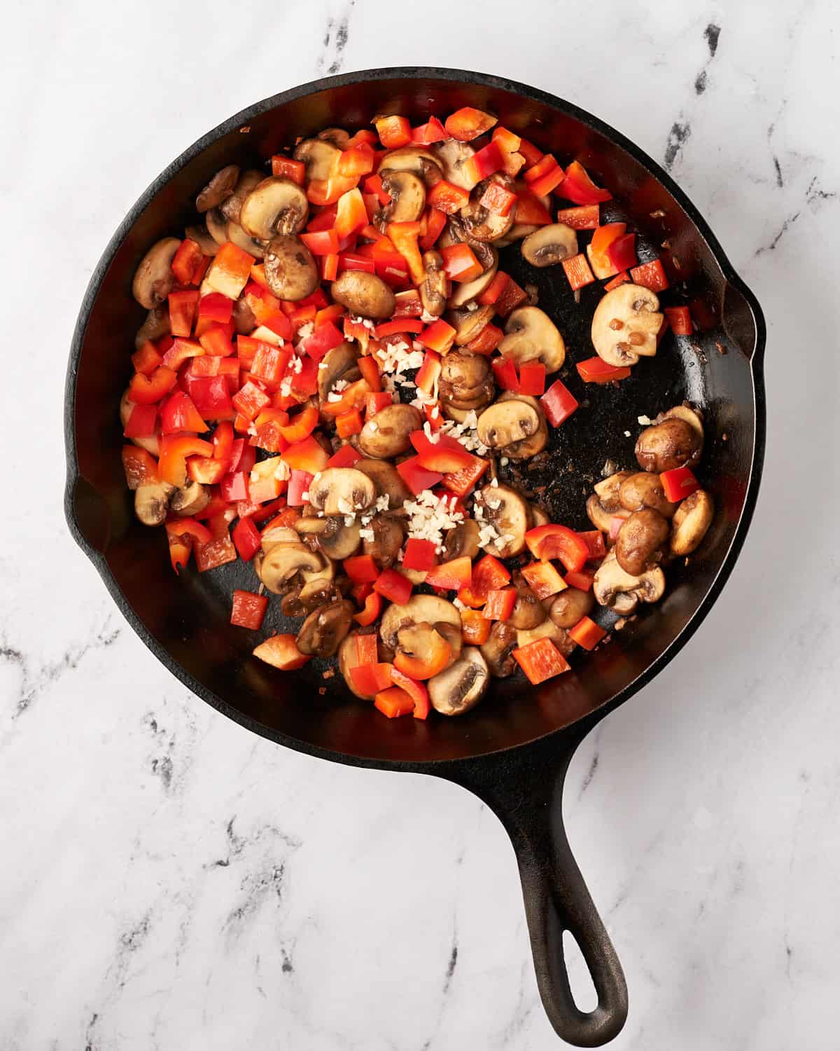 Cooking vegetables in a cast iron pan.