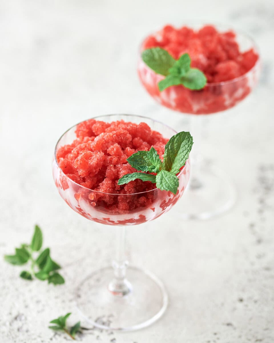 Two Coupe Glasses with Strawberry Lemon Granita with Gin.