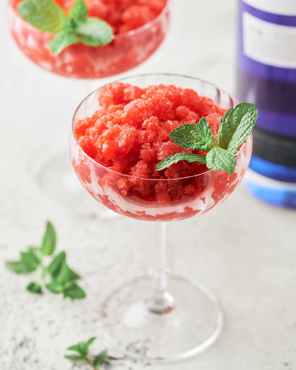 Strawberry Granita with Gin in a glass coupe.
