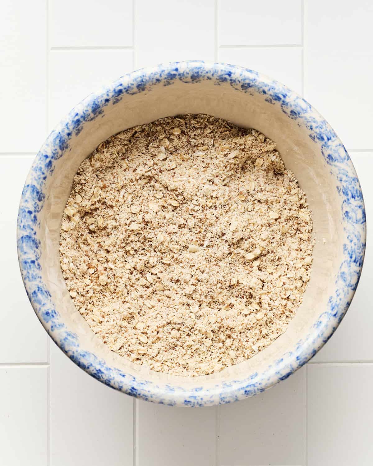 Mixing the dry ingredients for the cobbler toping a large mixing bowl