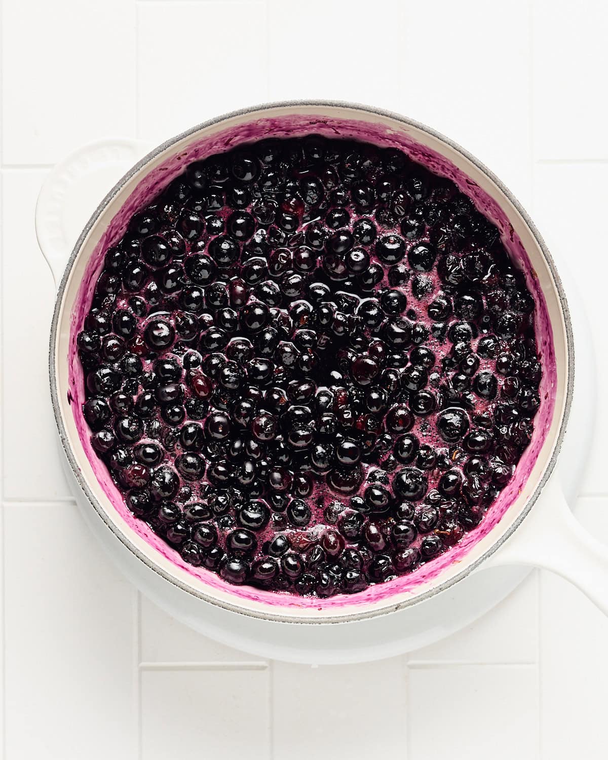 Blueberry compote cooking in a medium saucepan.