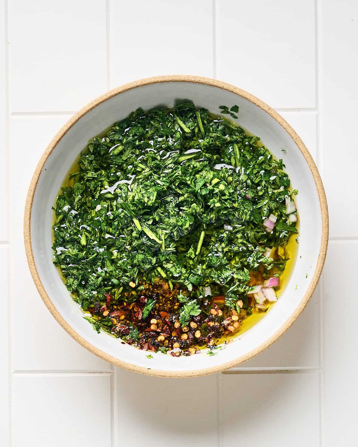 All ingredients about to be mixed in a bowl to make Chimichurri.