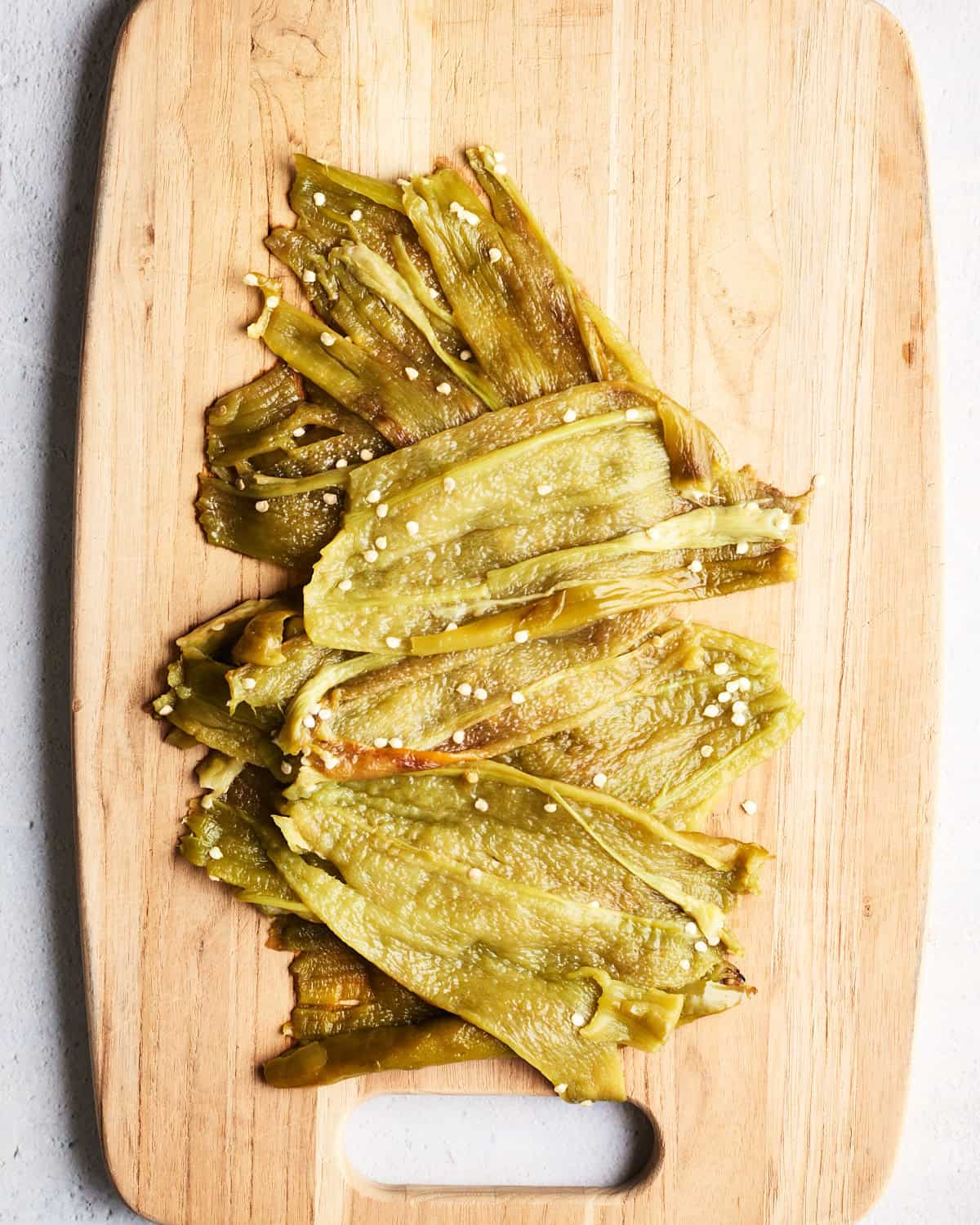 Broiled and seeded Hatch Chiles on a cutting board.