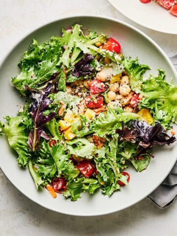Bowl of quinoa chickpea salad with lemon tahini dressing.