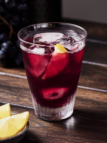 Summer red wine spritzer with slice of lemon in a glass.