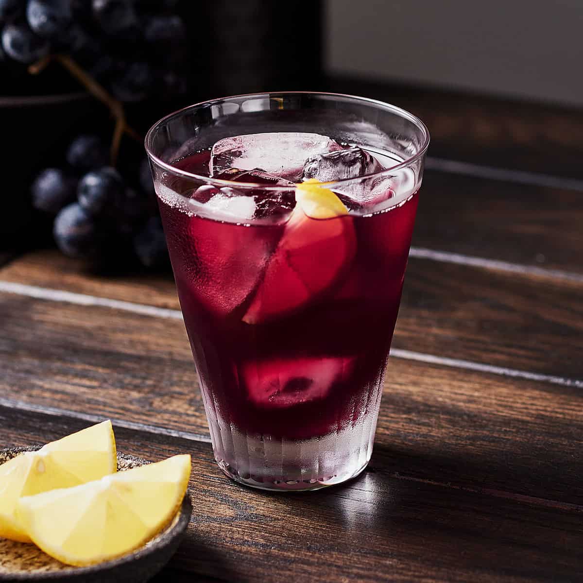 Summer red wine spritzer with slice of lemon in a glass.