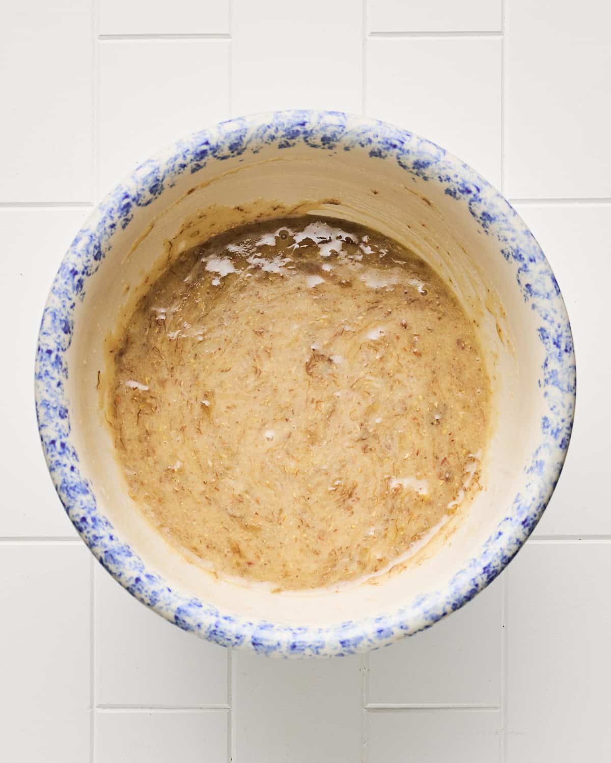 Wet ingredients in a bowl to make vegan banana bread.