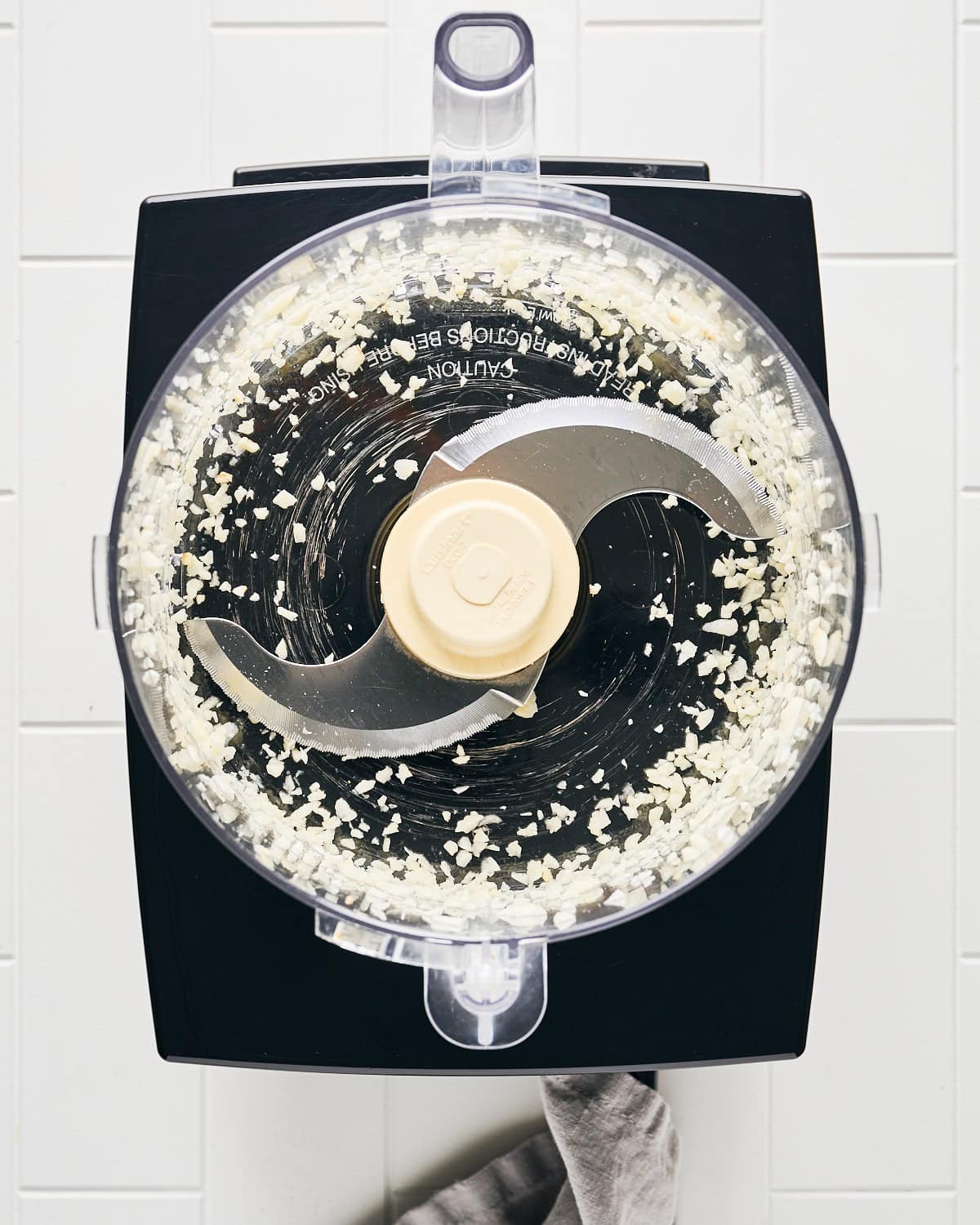 Chopped garlic cloves in a food processor with an S blade.