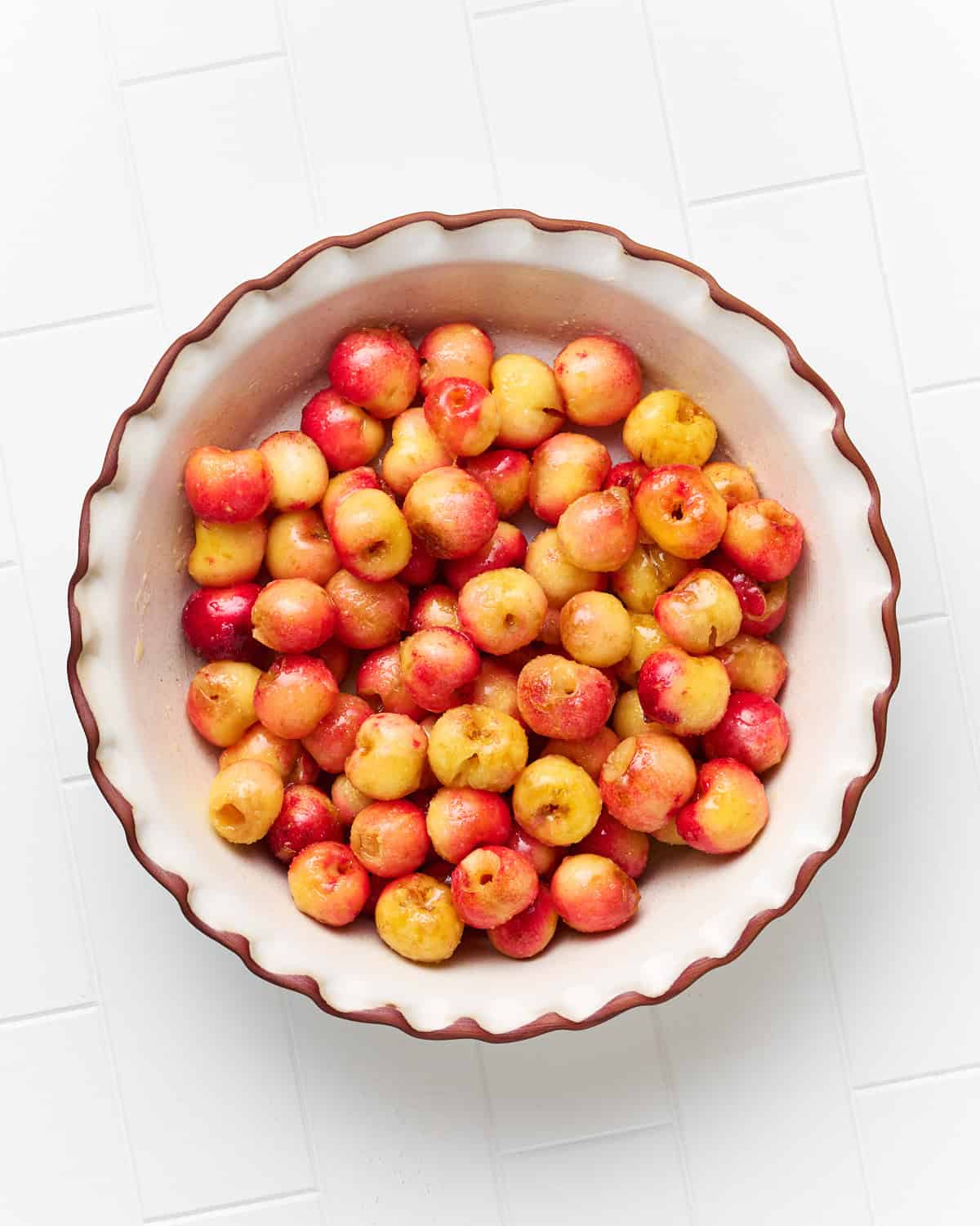 Rainier cherries mixed with sugar and other ingredients and placed in a pie dish.