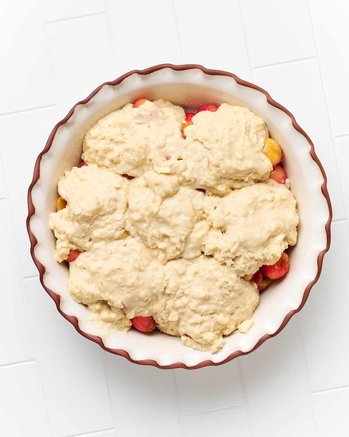 Unbaked Vegan Cherry Cobbler in a pie dish before being placed in the oven.