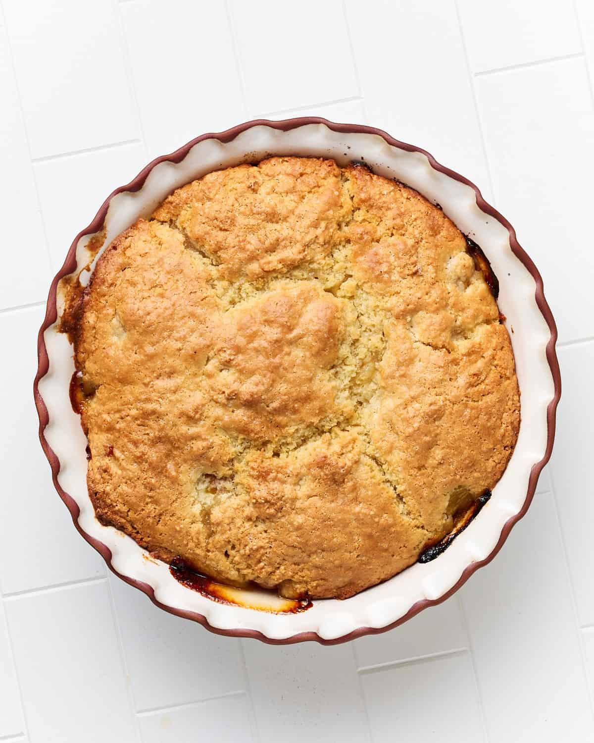 Baked Vegan Cherry Cobbler with Rainier Cherries in a pie dish with a fluted rim.