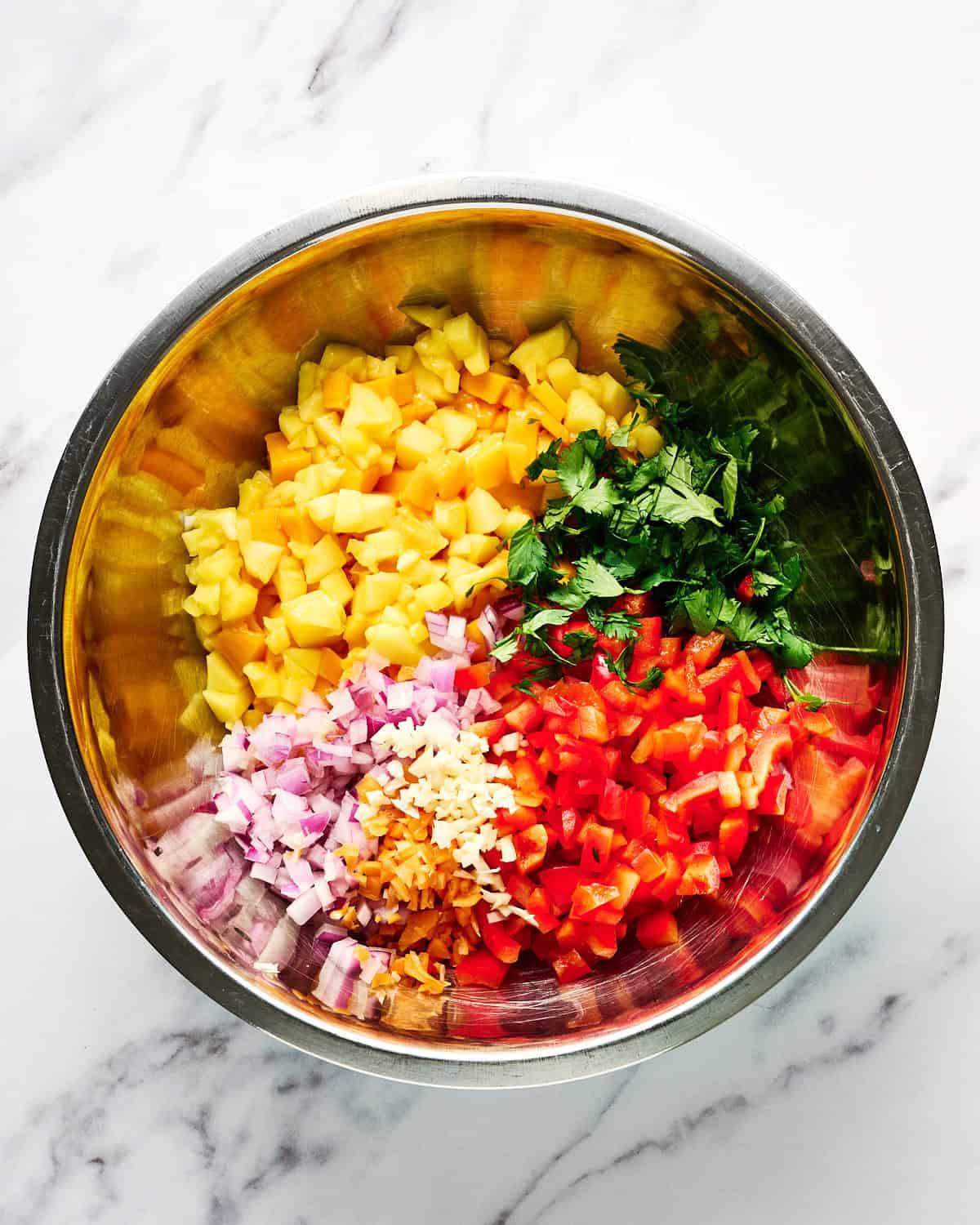 Ingredients for mango habanero salsa in a bowl.
