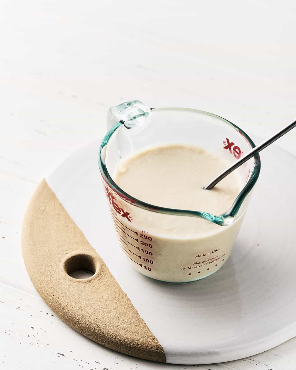 Vegan Buttermilk in a glass measuring cup.
