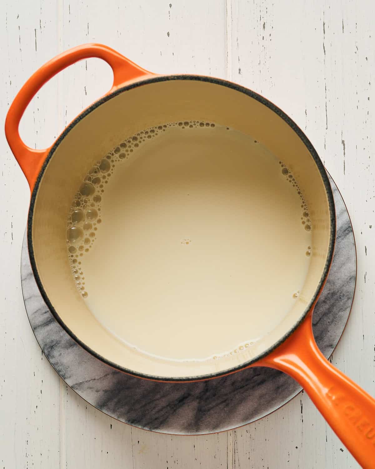 Heating soy milk in a small saucepan.