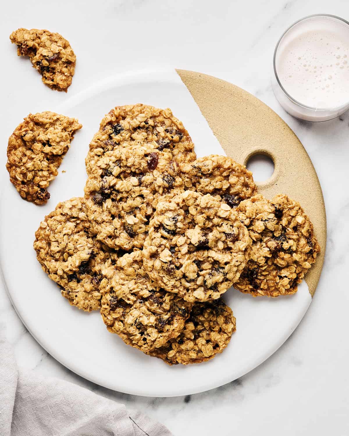 Vegan Oatmeal Raisin Cookies with Coconut Oil on a platter with almond milk.