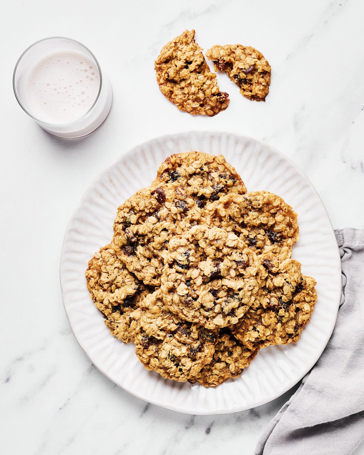 Vegan Oatmeal Raisin Cookies with Coconut Oil on a platter with almond milk.