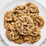 Vegan Oatmeal Raisin Cookies with Coconut Oil on a platter with almond milk.